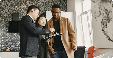 Three business people reviewing notes on a clipboard