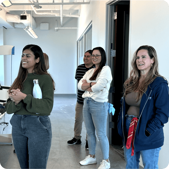 Ownwell employees standing near each other and working together during a conference